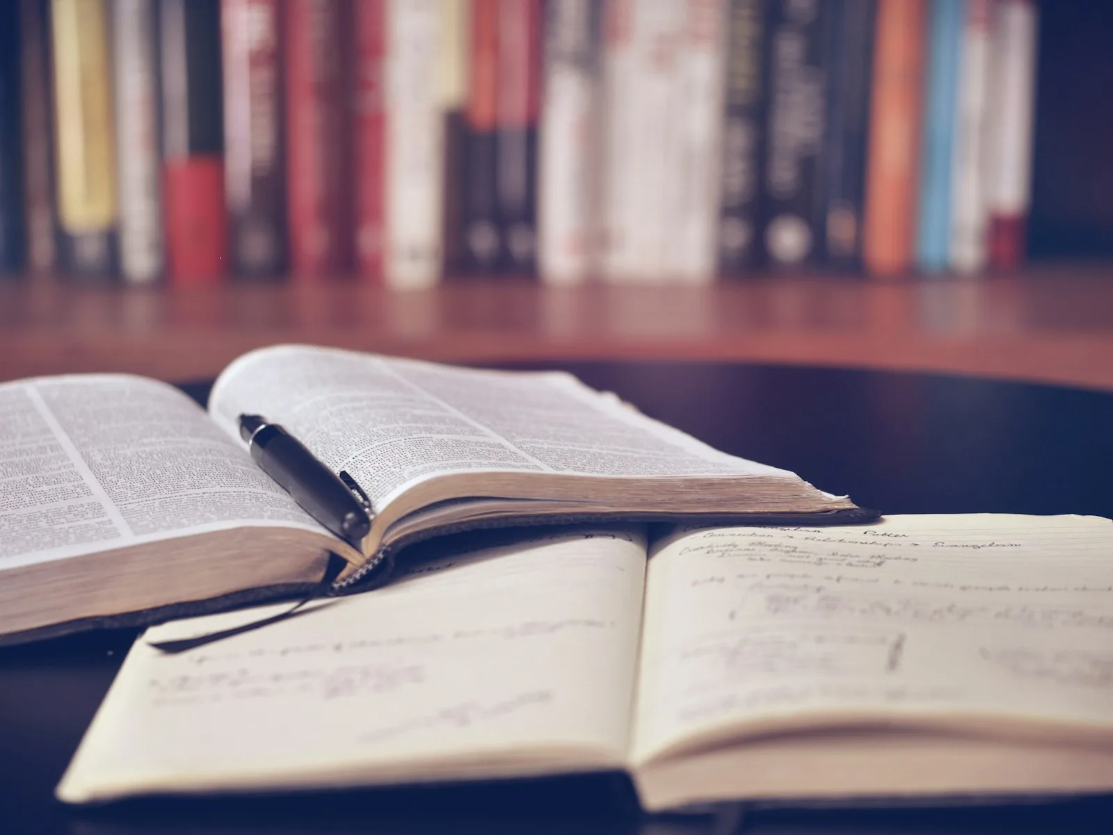 Photo of financial books that someone is reading in order to understand more of how debt works and how to get away from it.