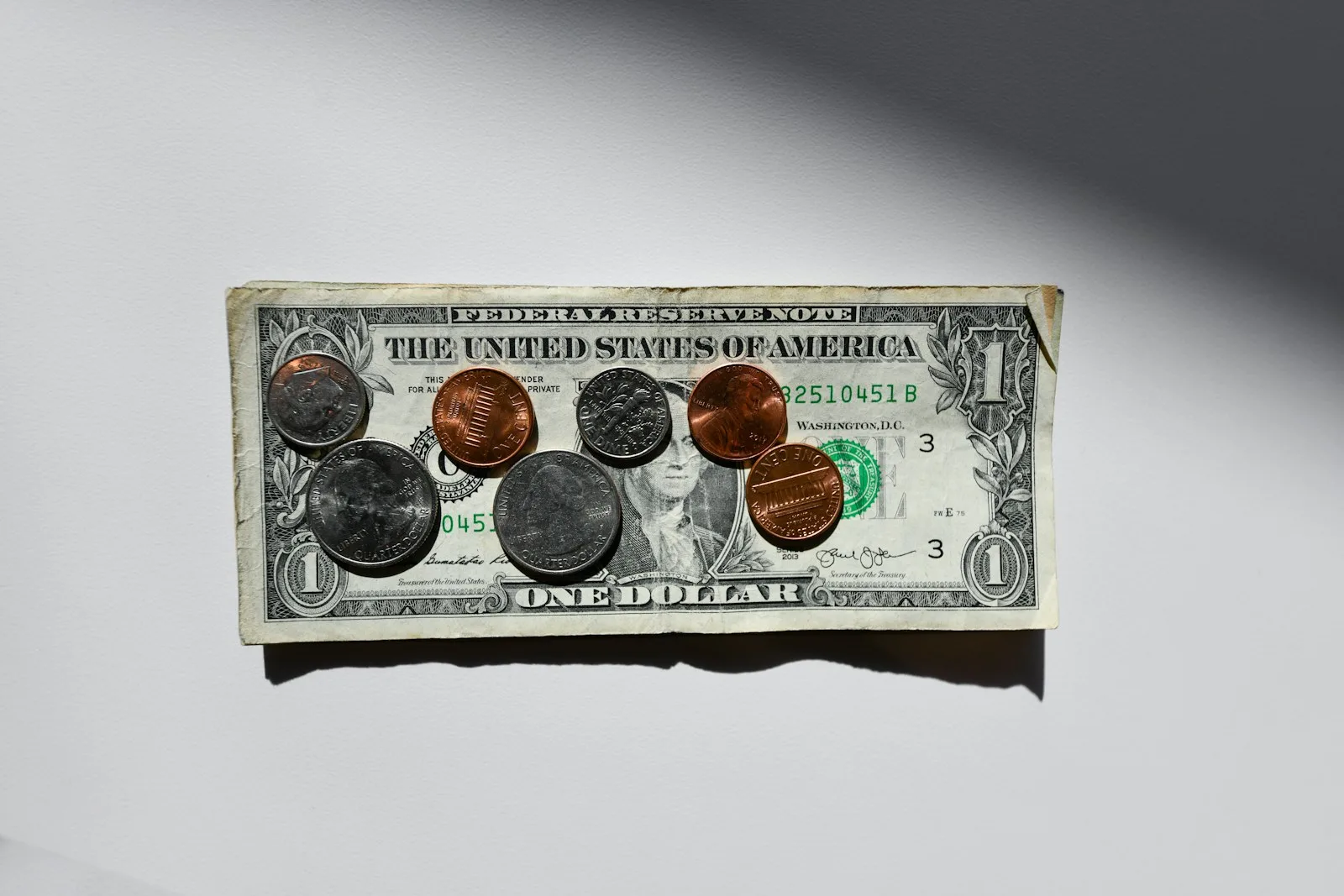 Image of a one dollar bill and a few coins