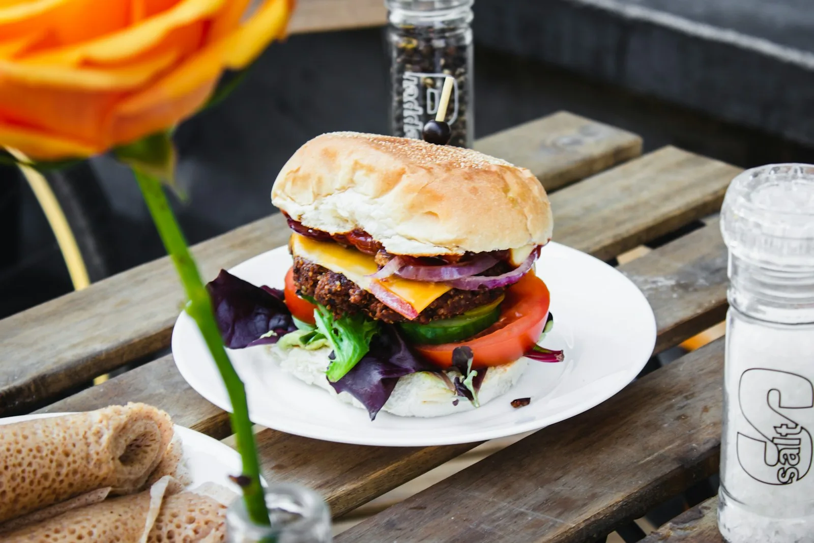 A picture of a burger on a white plate