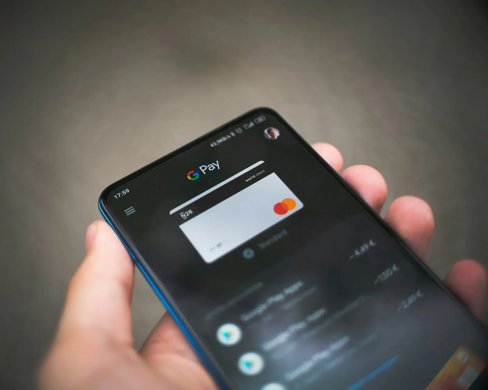 A person checking his automated transactions through a mobile banking application