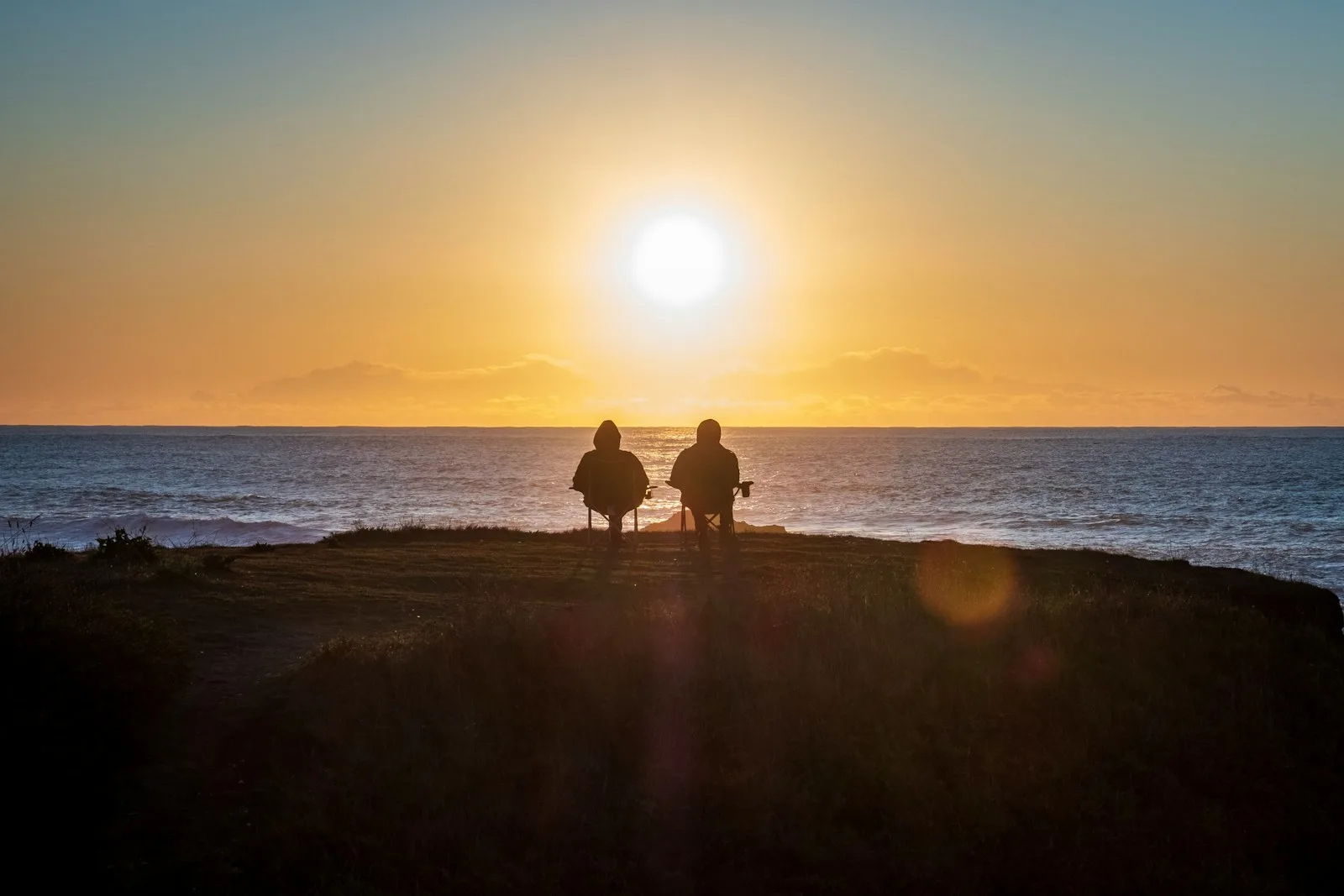 A couple enjoying the retirement days of their life by a sunset