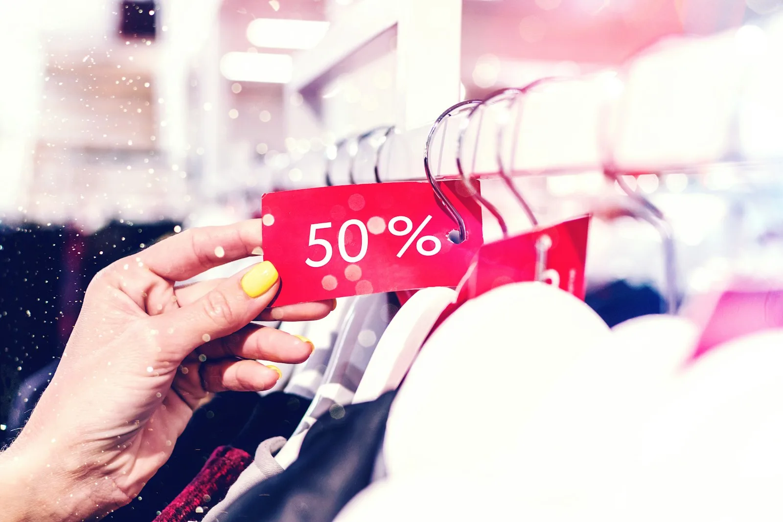 Image of a person buying a cloth after checking the discount rates. Something that we all should do in order to save more.