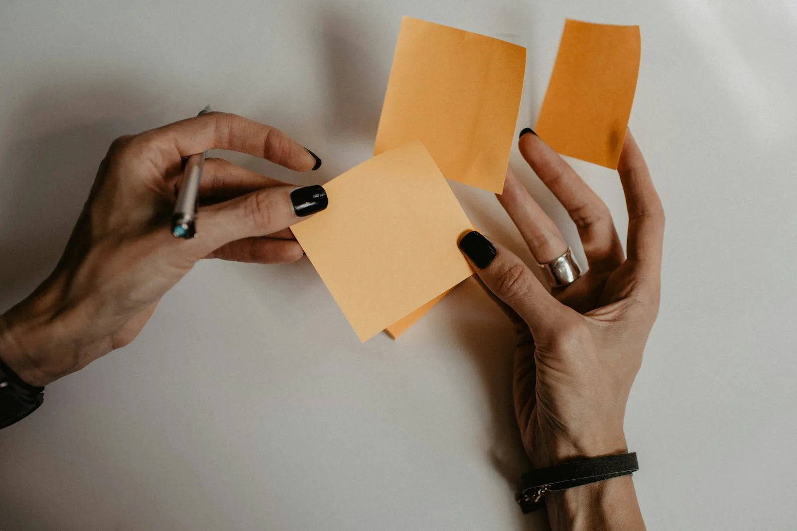 Image of someone trying to choose a sticky note and write ideas on it