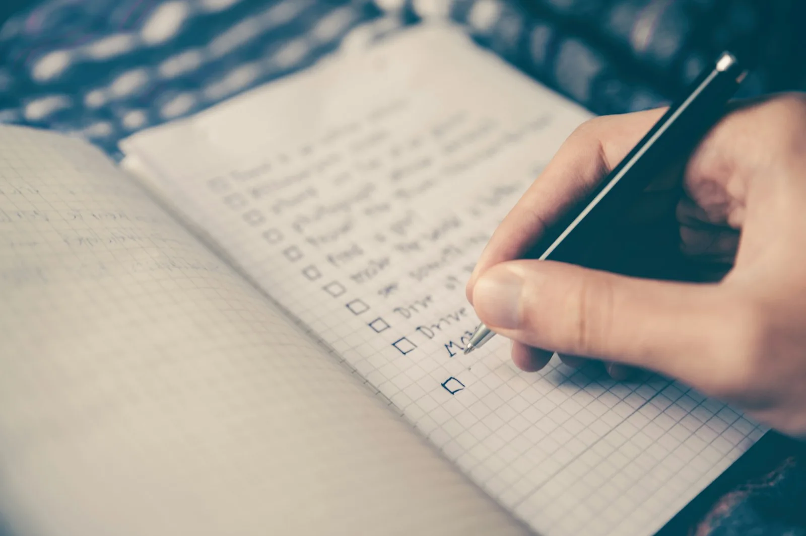 A person creating a plan with checklist for their financial goals