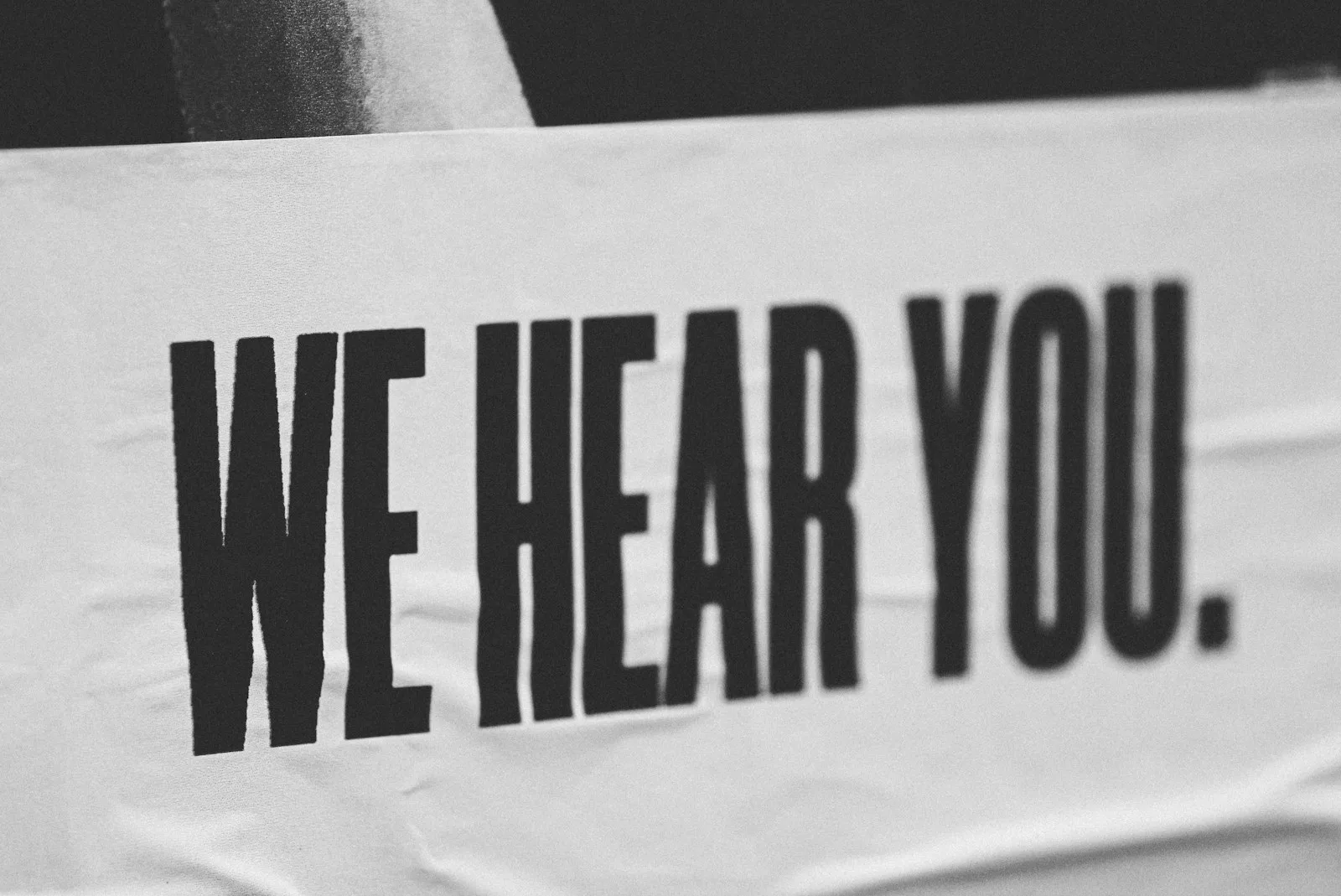 A poster stating “We hear you”. A sign of empathy, something that’s highly important in negotiation.