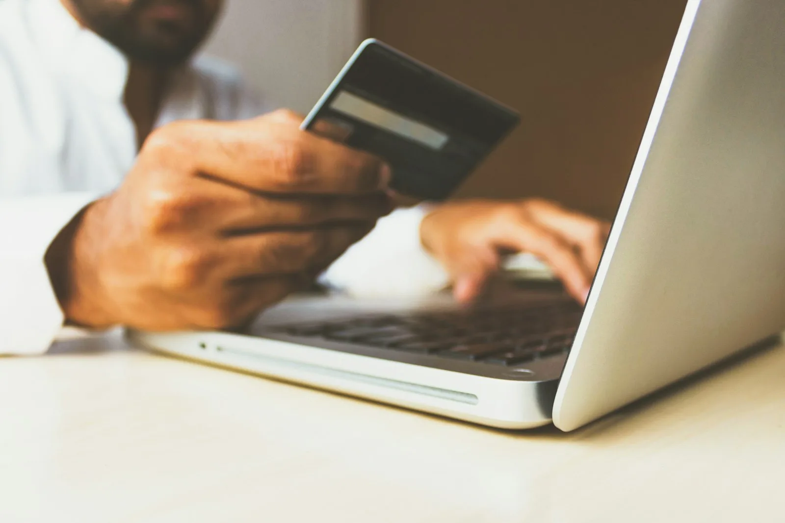 A person making a payment for his Insurance Premium through his laptop