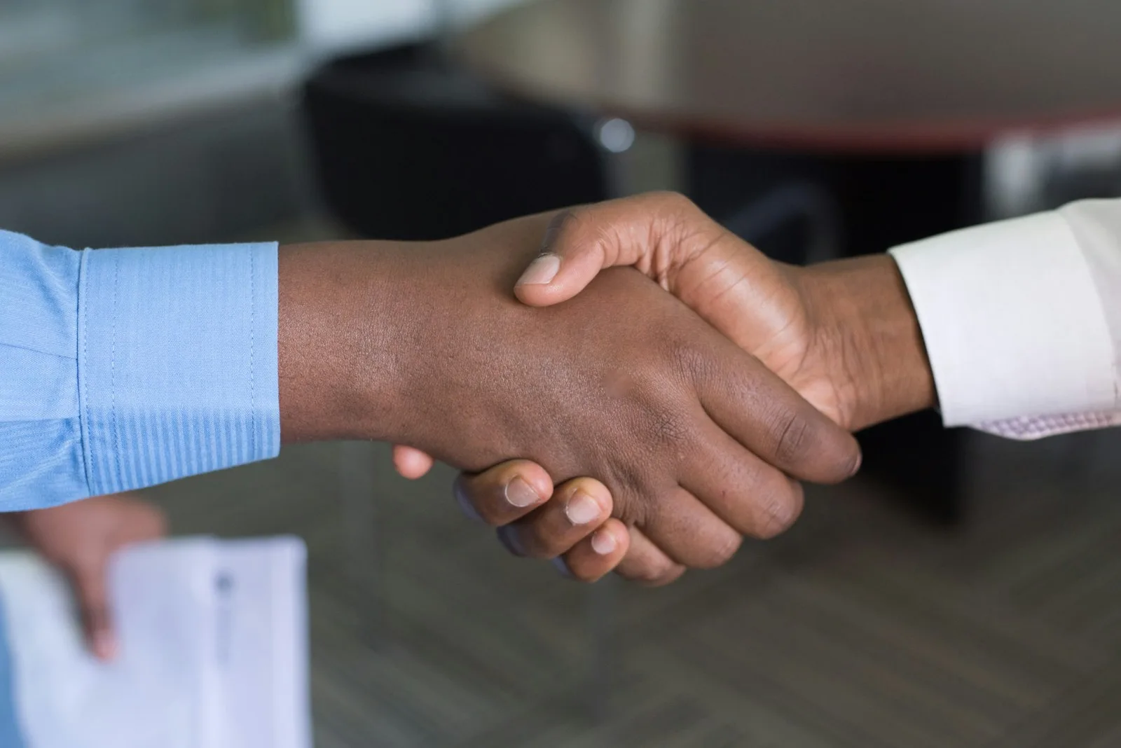 Image of a person shaking hands after consulting with a counseling agency for debt management plan