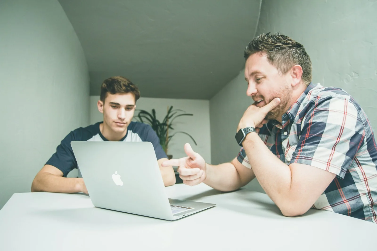 A father and his son discussing on their estate plan together