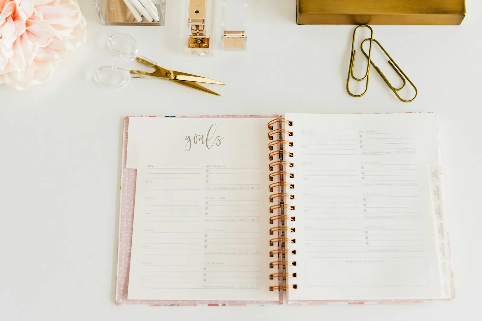 A planner with the word “Goals” written on top of it