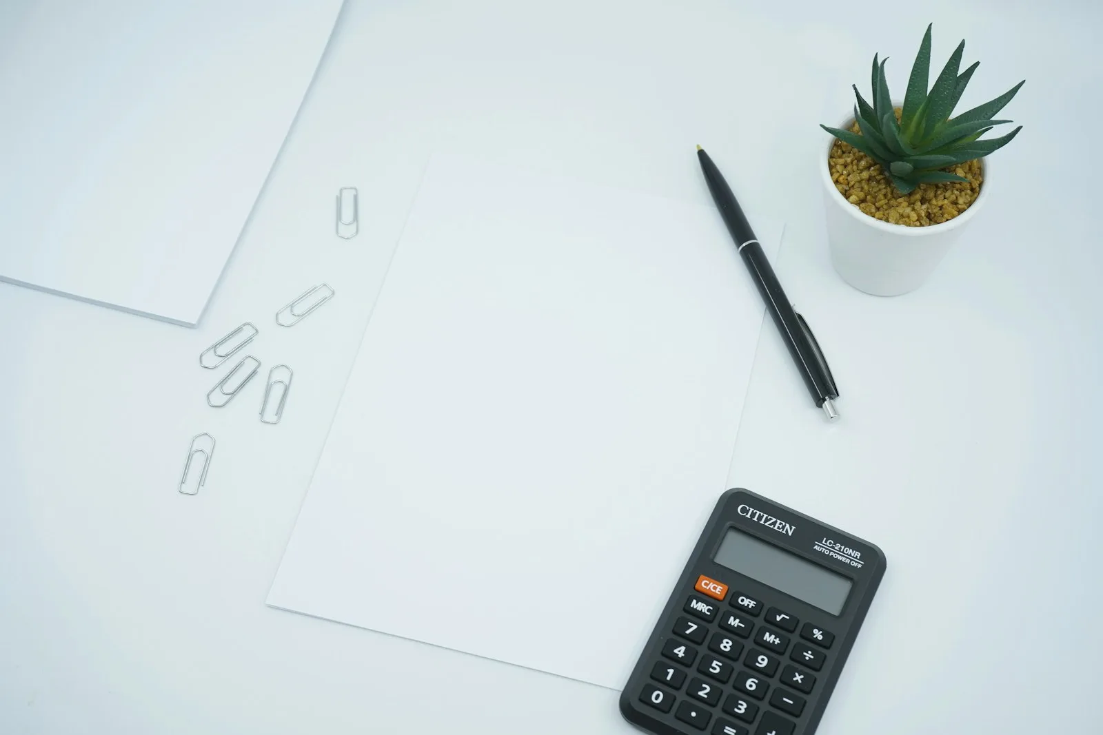 A person using a calculator to sum out all expenses