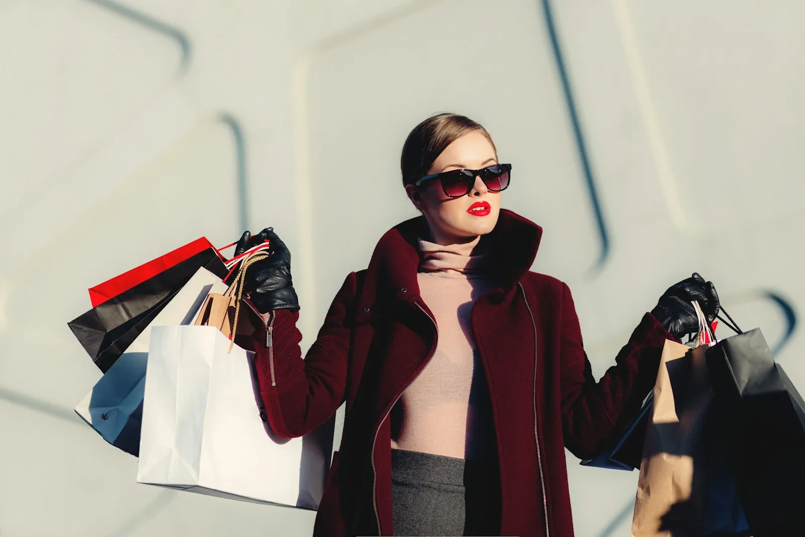 Image of a person carrying a lot of shopping bags. We need to be more disciplined while making lifestyle choices in case we want to reduce our debt.