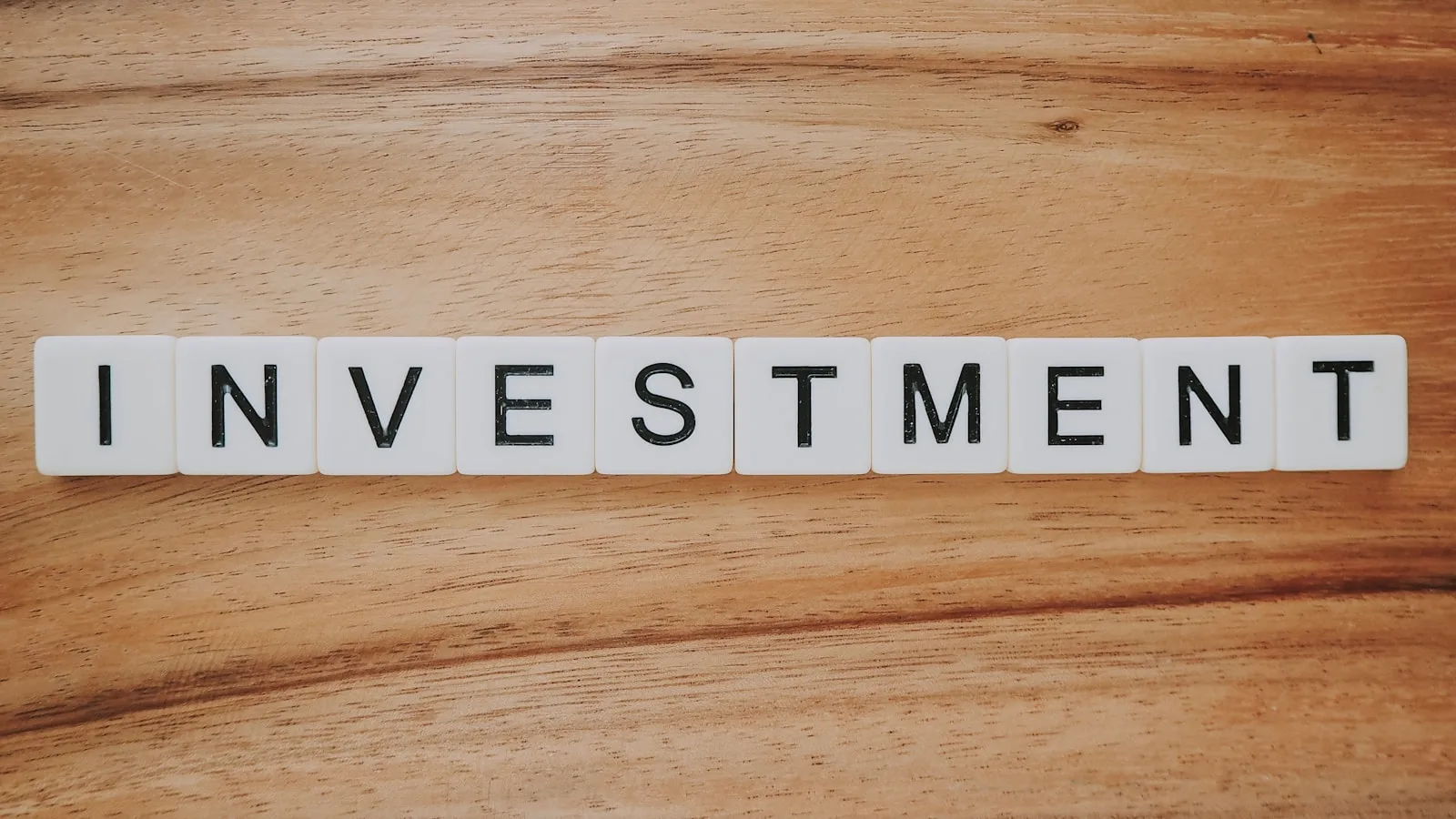 Blocks of letter forming the word “INVESTMENT”