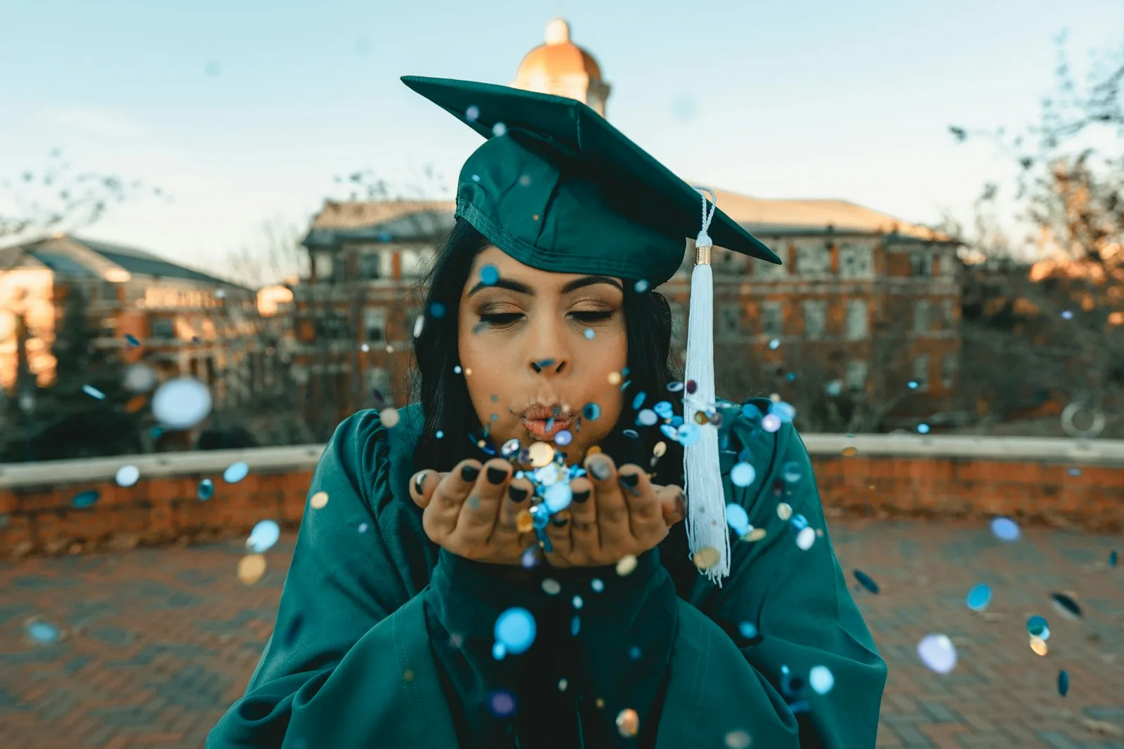 A student looking happy after clearing her student loan while graduating
