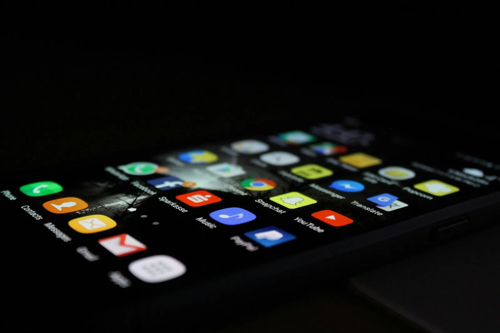 Photo of a mobile phone showing multiple applications on it