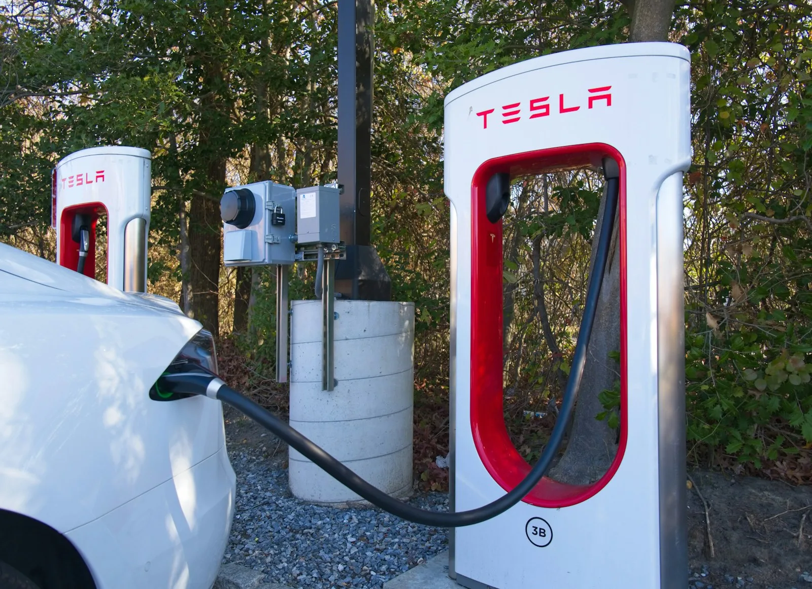 Image of a car getting charged through electricity which is an eco friendly option