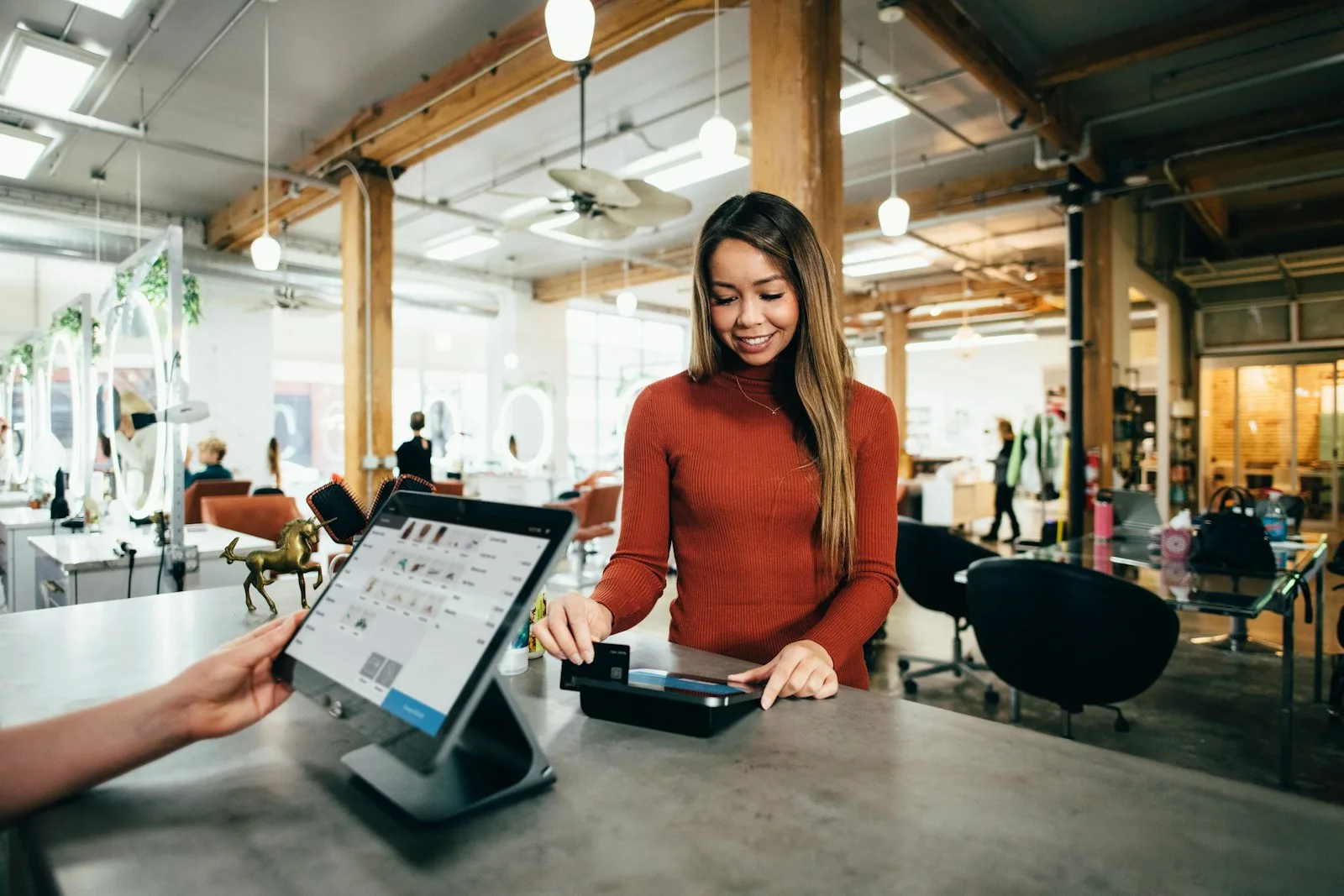 An image of a person happily making a purchase, indicating financial stability and success.