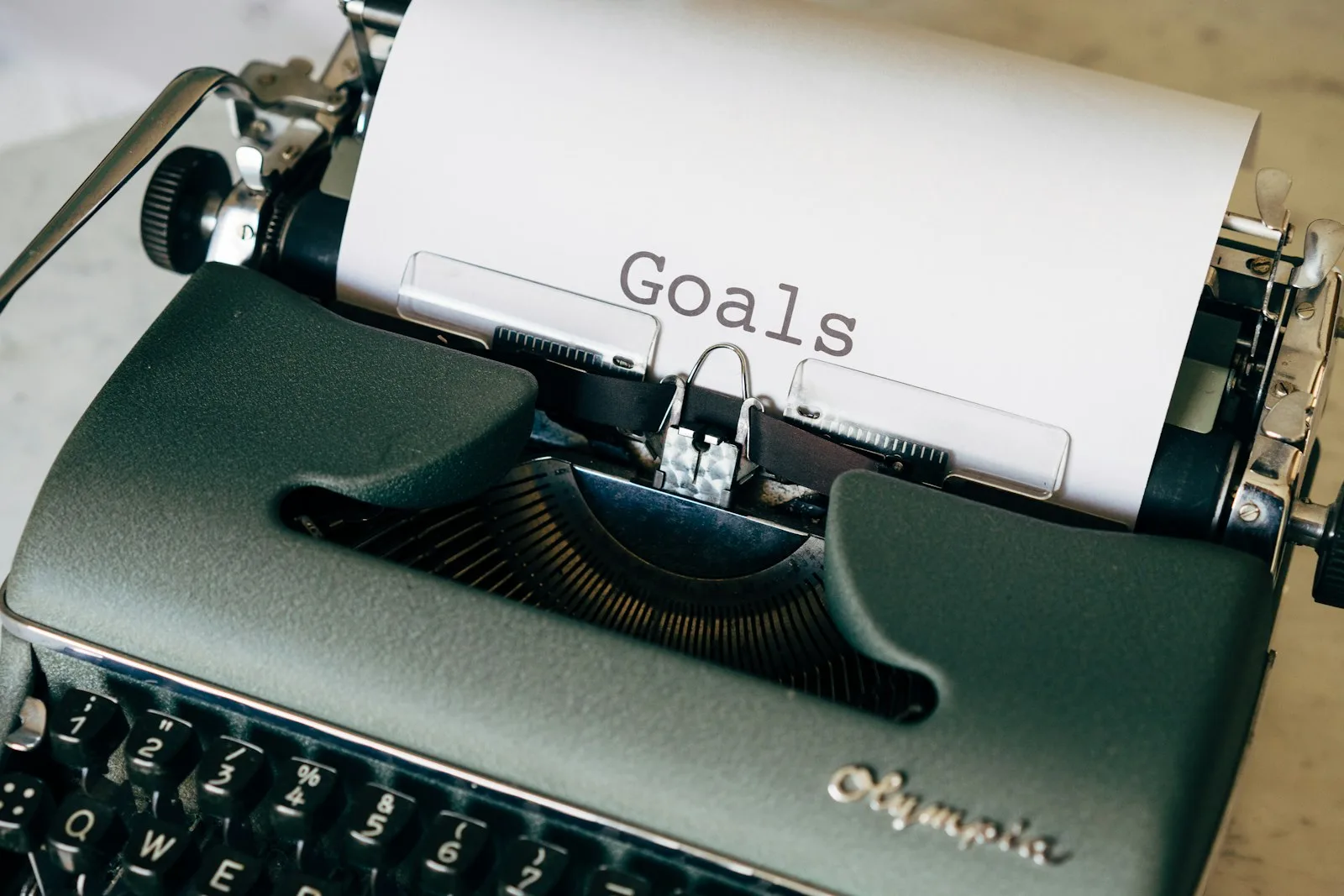 The word “Goals” printed on a piece of paper with a typewriter