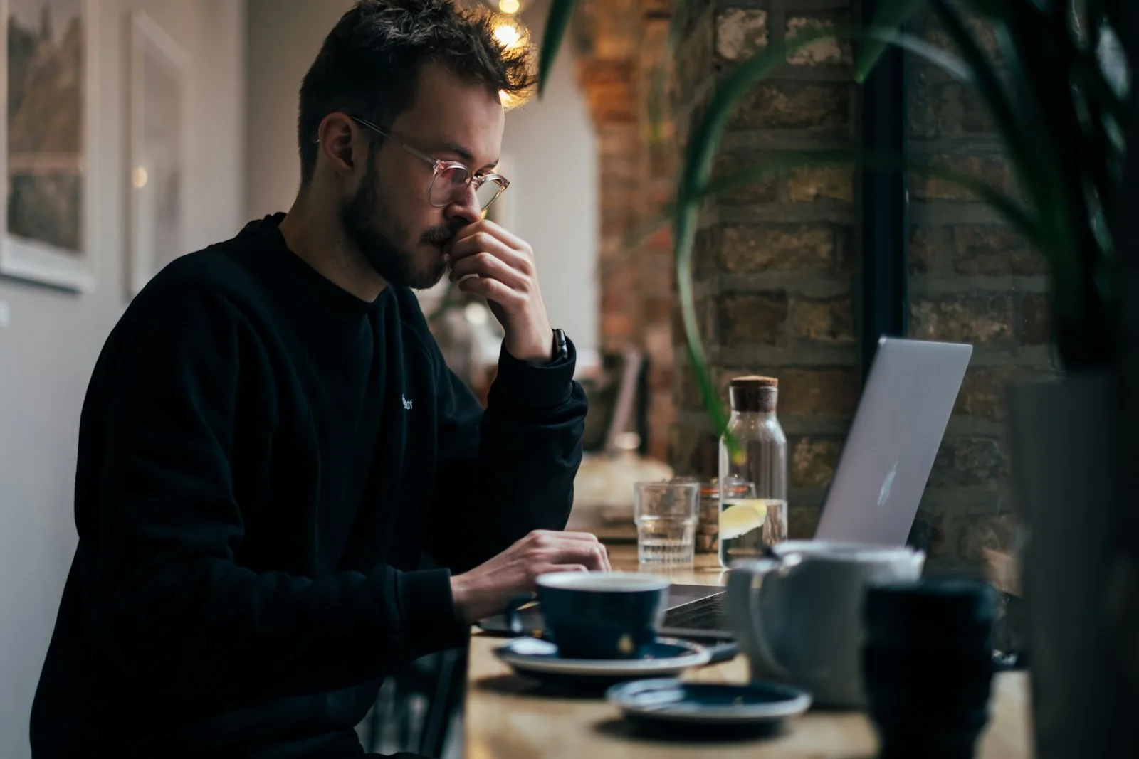 Image of a person reading through debt consolidation options over a laptop