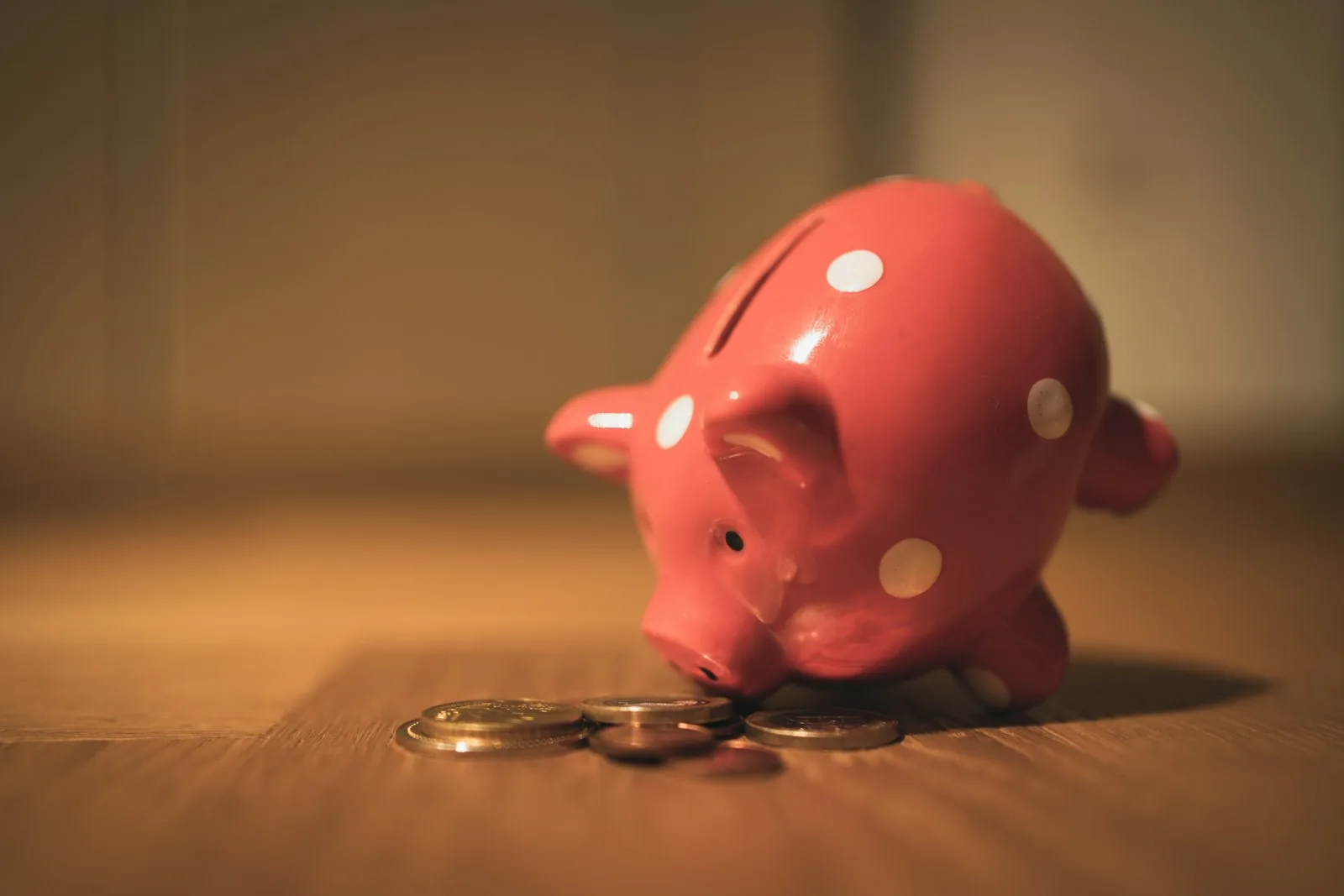 Photo of a piggybank falling over it’s nose