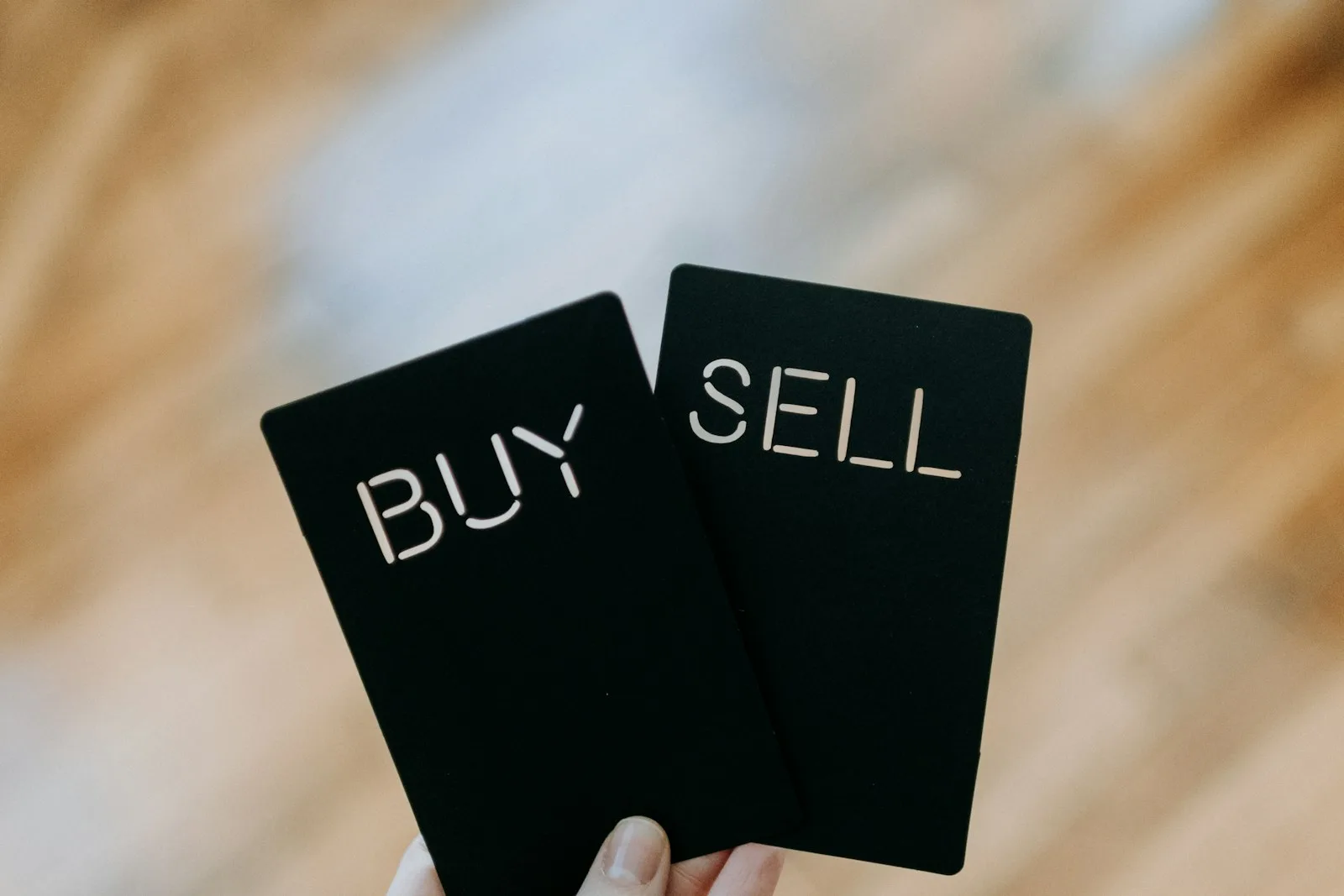 Image of two cards, one saying “BUY” and the other says “SELL”