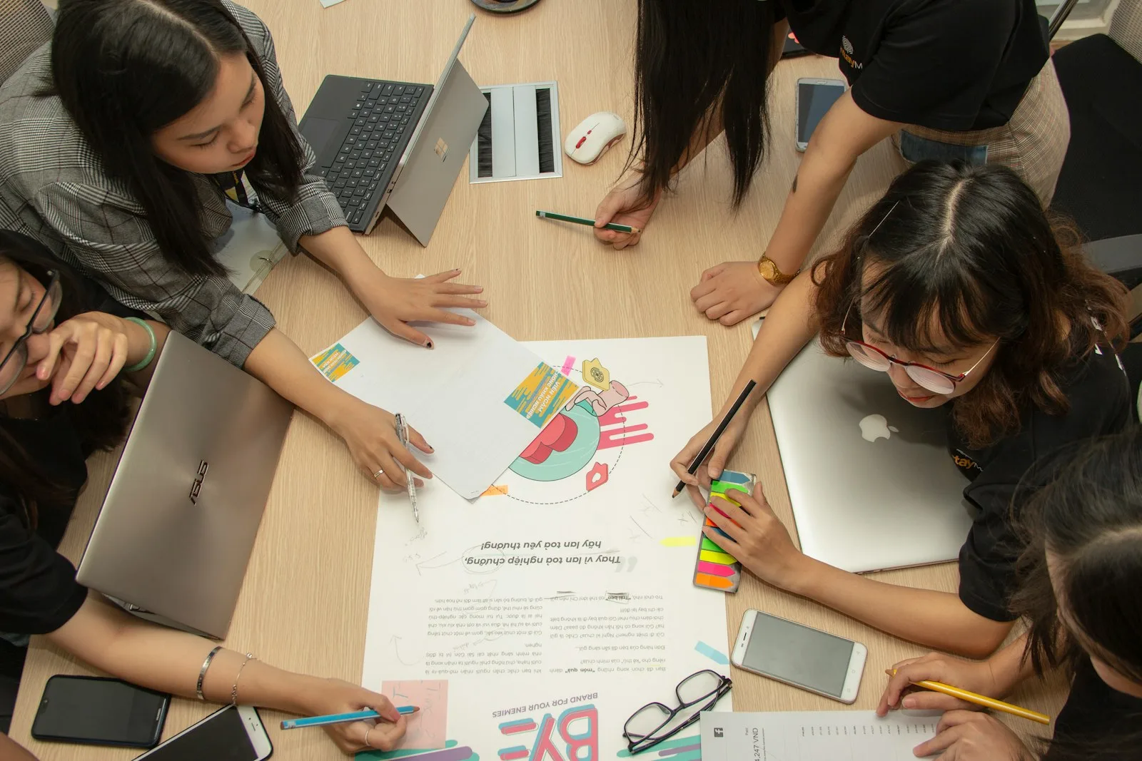 A group of young kids learning together through a group project