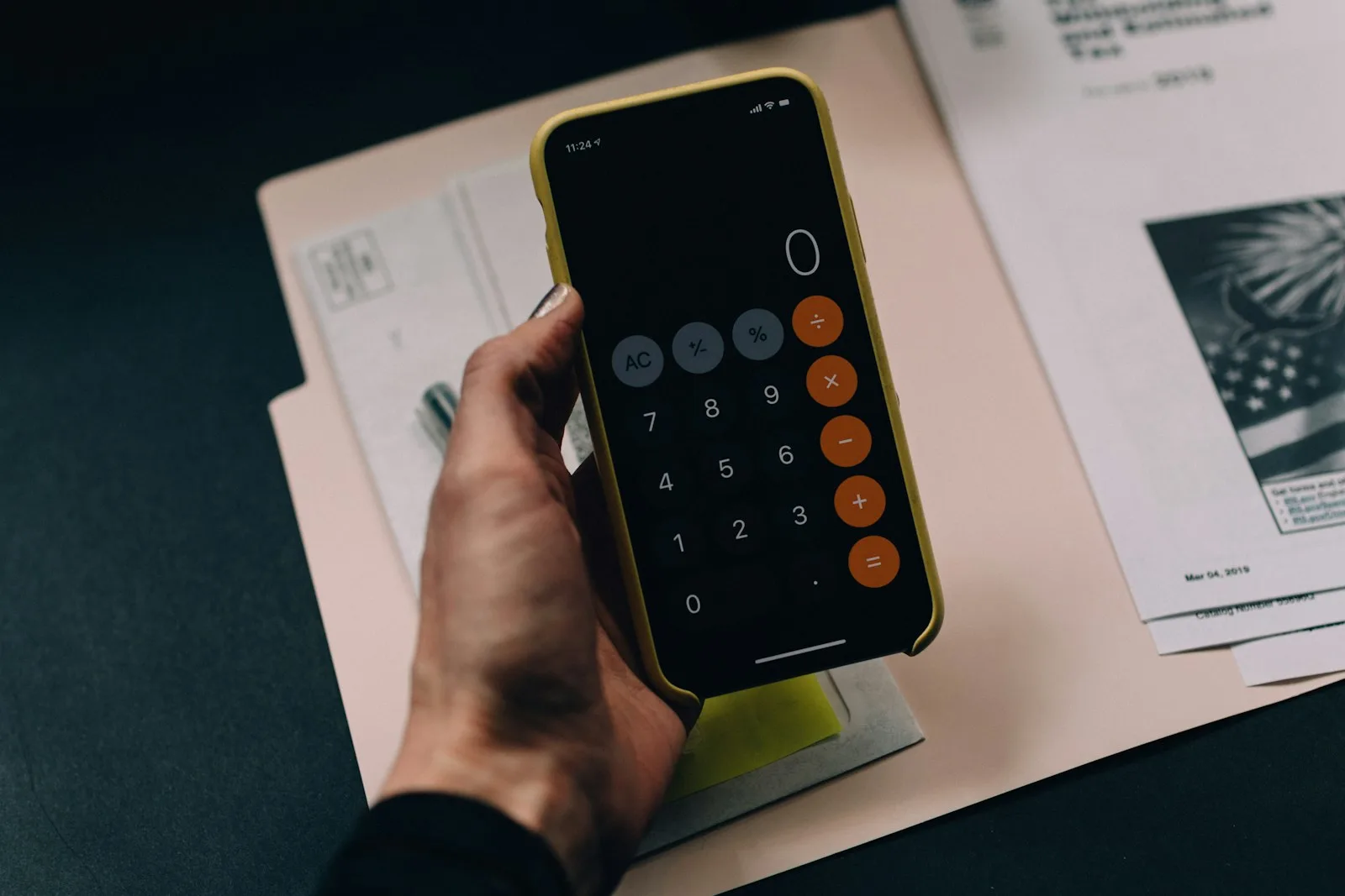 A person using his mobile phone to create a budget for himself