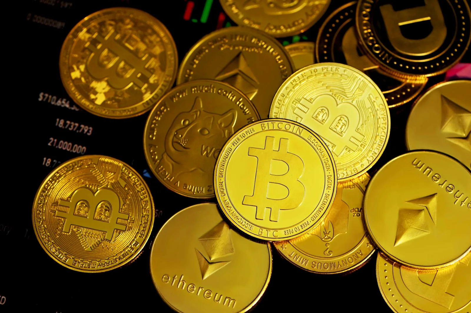 Popular cryptocurrency logos printed on physical gold color coins