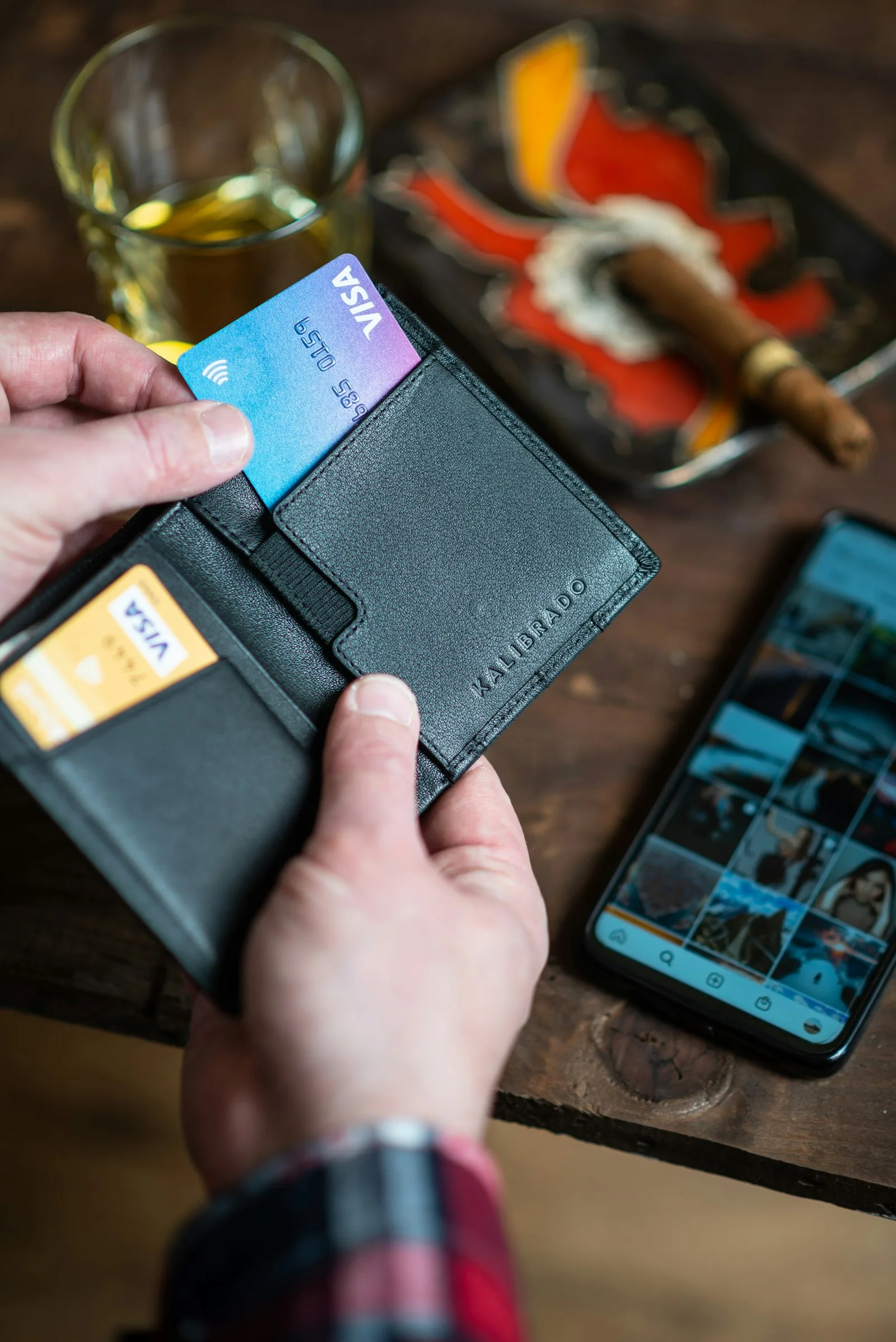 A person using credit card to make a purchase instead of cash in order to establish a credit history